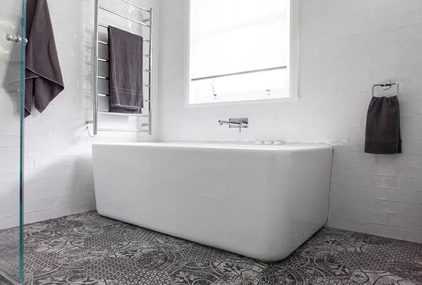 Bright modern bathroom with white wall tiles and patterned floor tiles in Central Coast NSW